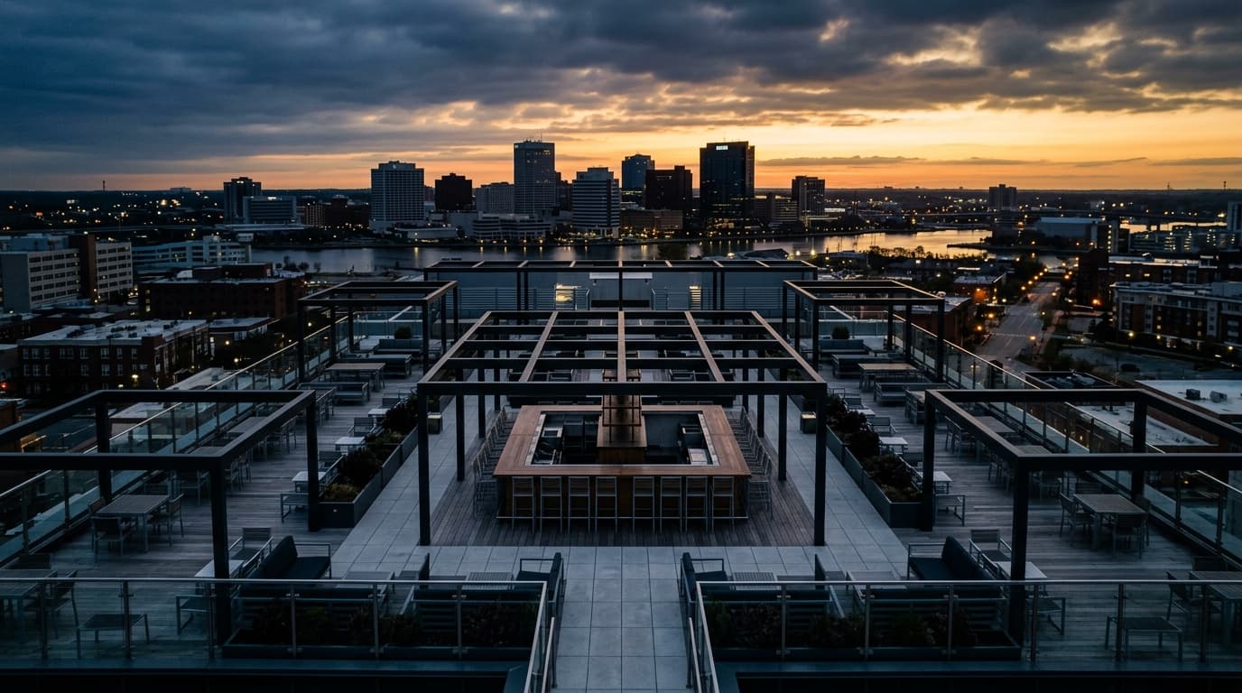 An overhead 24mm flat-lay view of the Main building's geometric rooftop patio at dawn. Overcast light illuminates the empt...